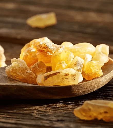 Natural resin of Frankincense and Myrrh in a wooden spoon, key ingredients for anti-aging skincare.
