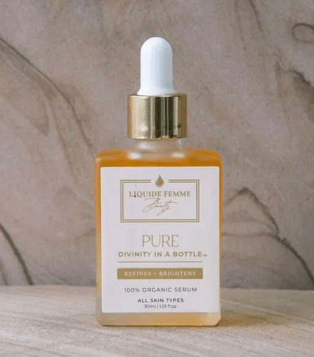 PURE serum bottle by Liquide Femme, a 100% organic product for all skin types, refines and brightens complexion.
